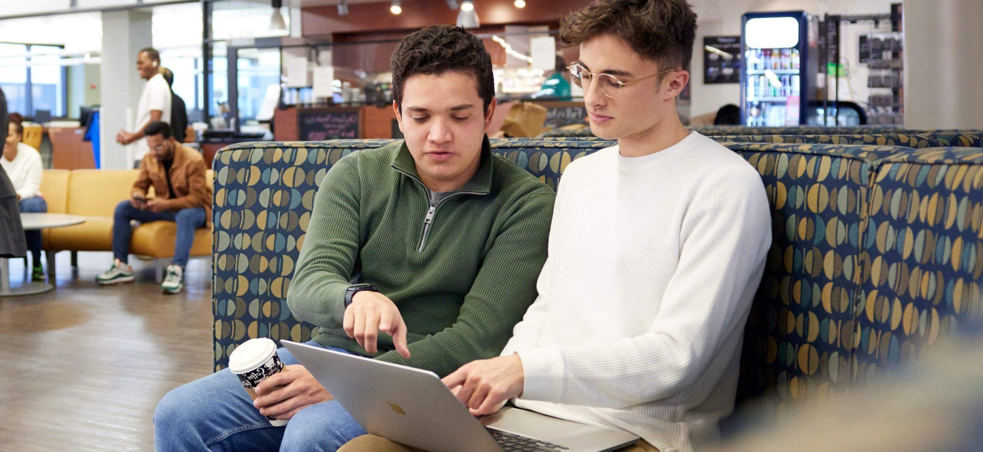 Students looking at a laptop.